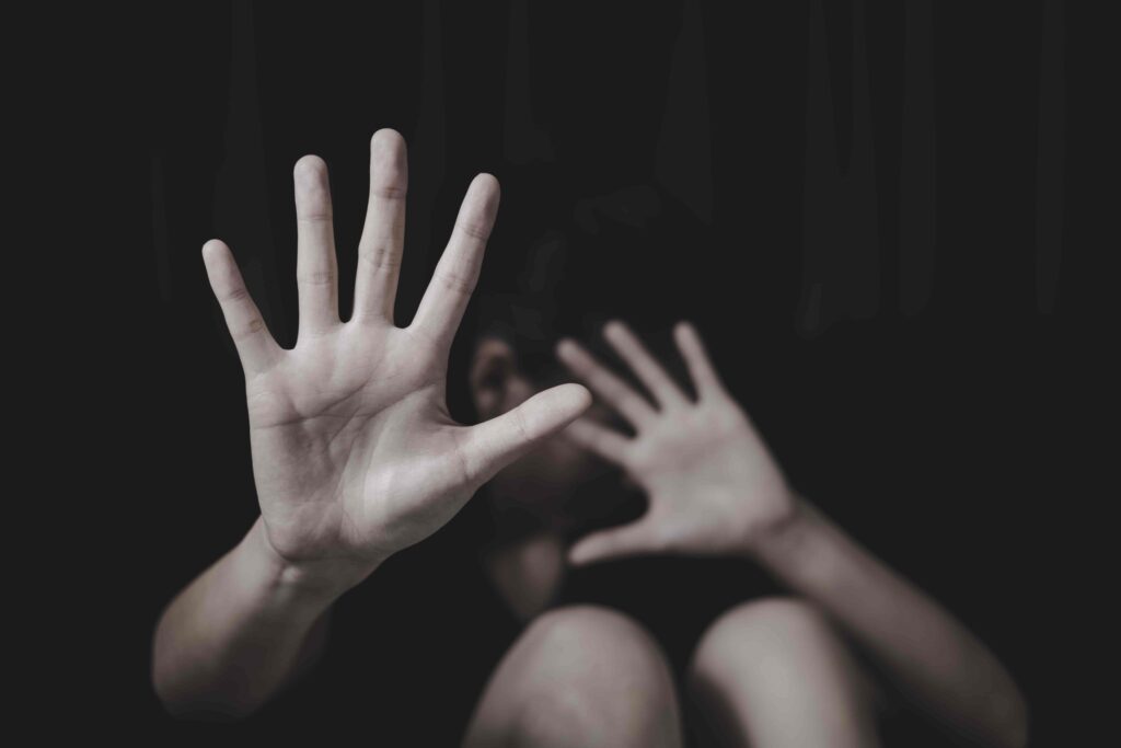 Victim raising hands in fear as symbol of domestic violence and abuse prevention